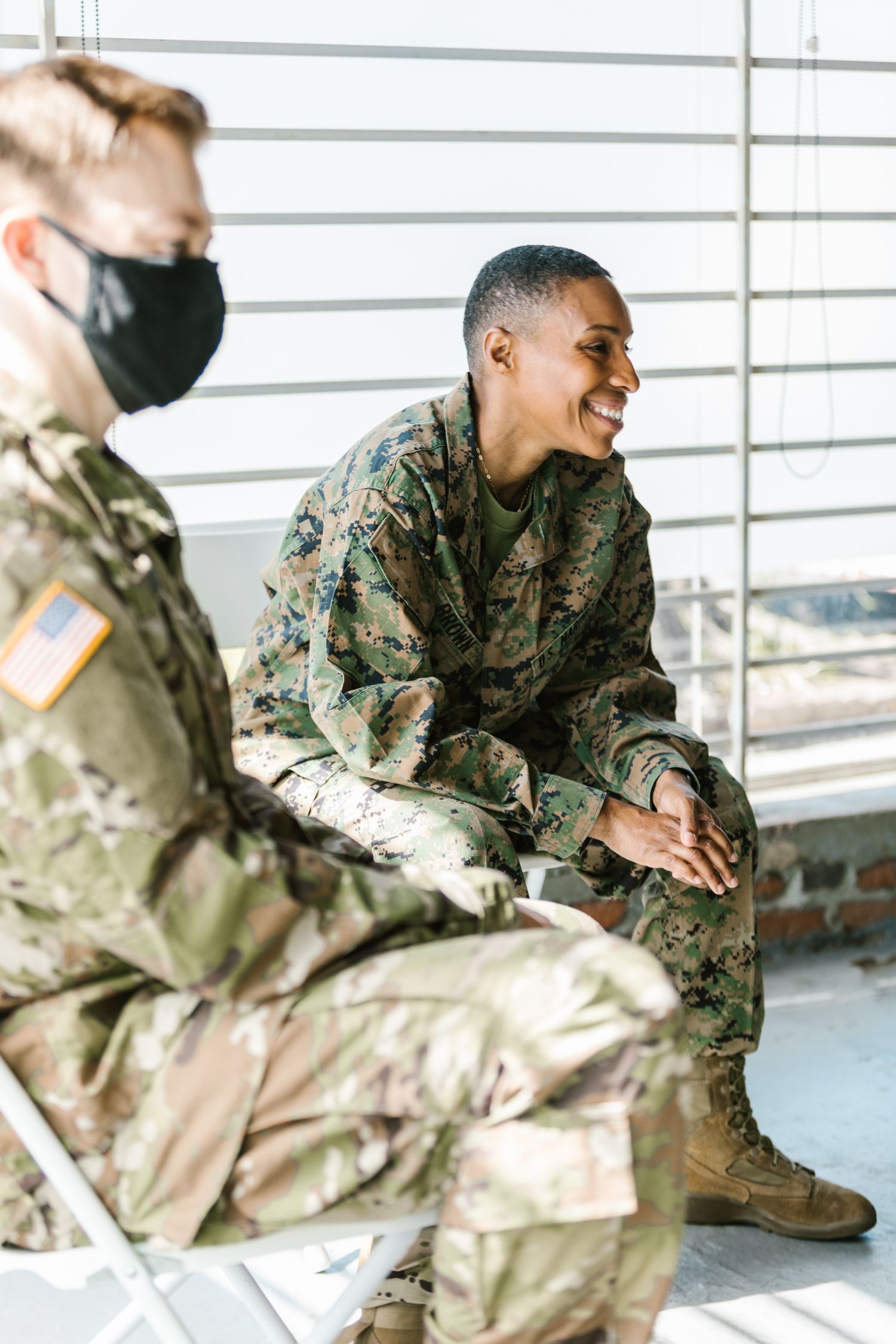 A veteran smiling during a supportive group session in a sunlit room