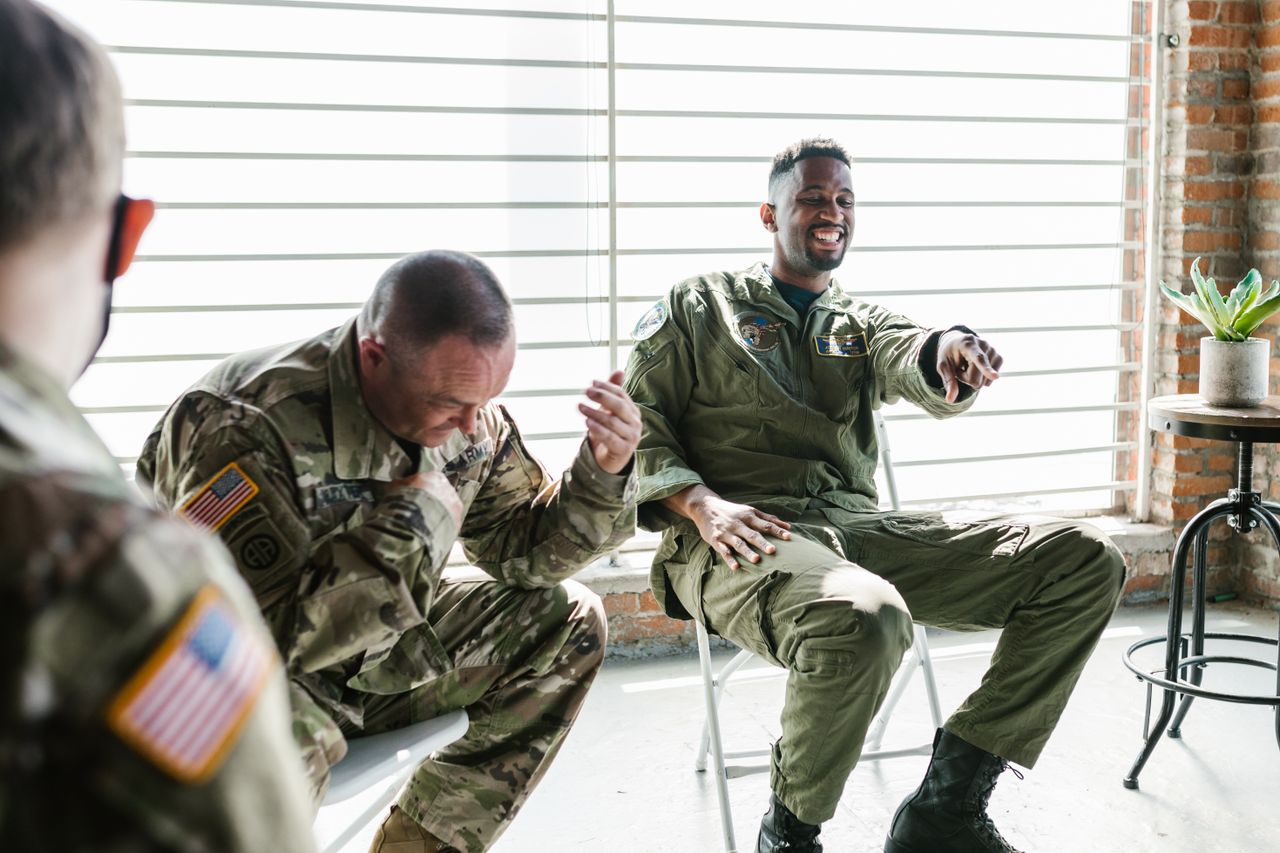 Veterans sharing a warm, supportive moment together in a group session